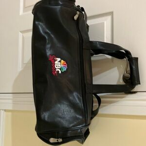 Leather duffle bag with NBC Sports logo.